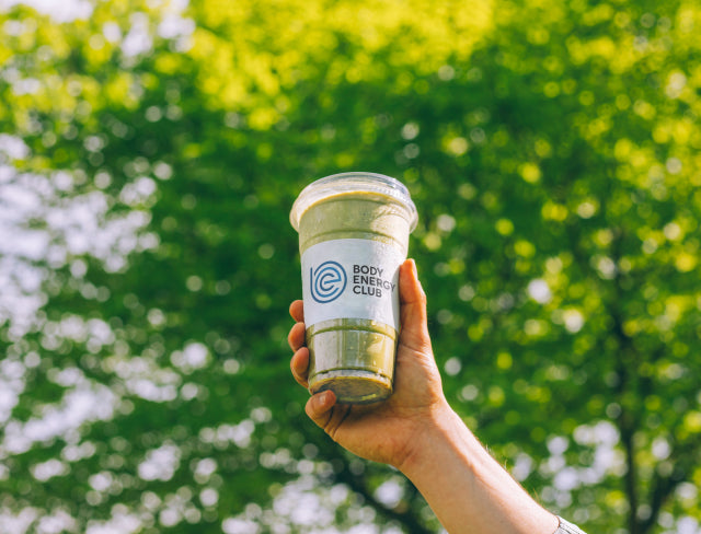 Hand holding a Body Energy Club Matcha Smoothie