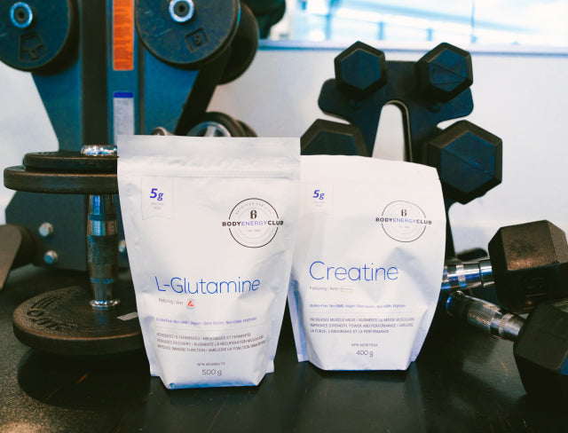 Body Energy Club Sports Supplements - L-Glutamine 500g pouch, Creatine 400g pouch with weights in the background